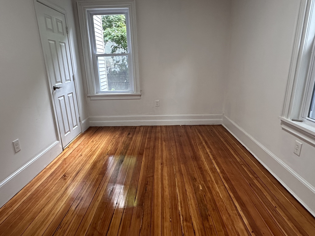 46 Theodore Street Boston, MA 02124 - Photo 30 of 32 a view of empty room with wooden floor and fan