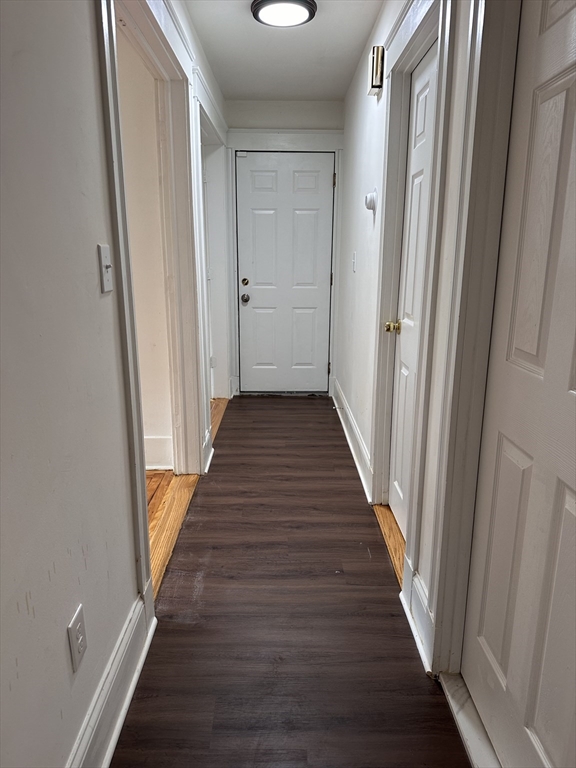 46 Theodore Street Boston, MA 02124 - Photo 31 of 32 a view of a hallway with wooden floor