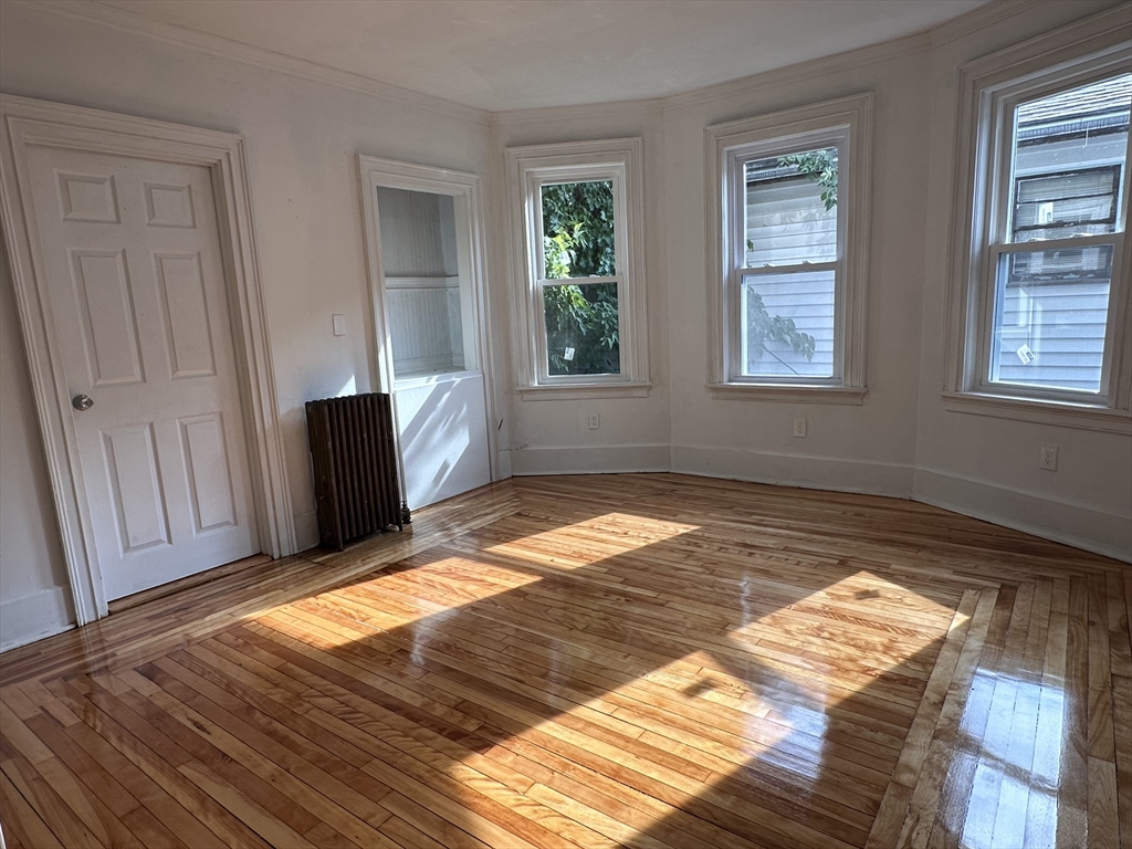 46 Theodore Street Boston, MA 02124 - Photo 8 of 32 a view of a room with wooden floor and windows
