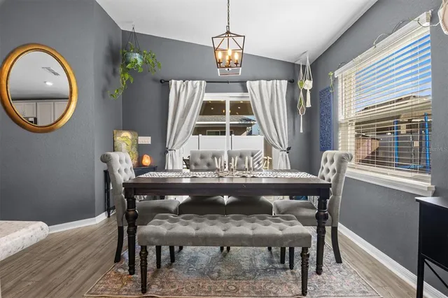 a view of a dining room with furniture window and wooden floor