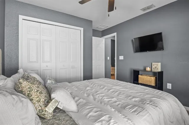 a bedroom with a bed and a television