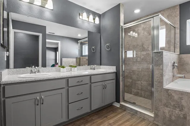 a bathroom with a granite countertop sink mirror and shower