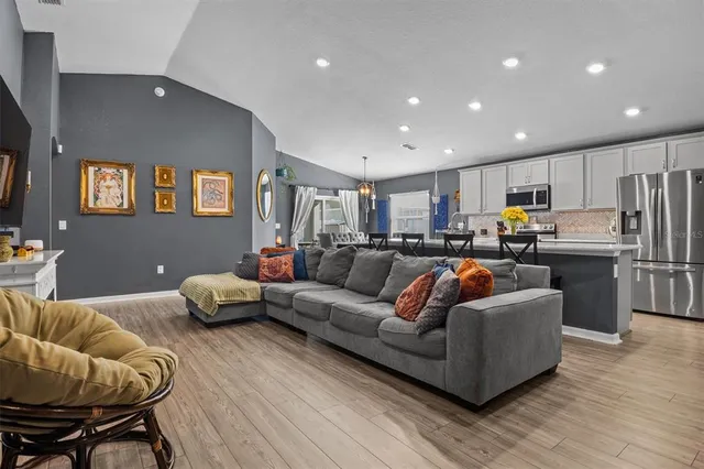 a living room kitchen with furniture and kitchen view