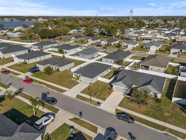 an aerial view of a residential houses with outdoor space