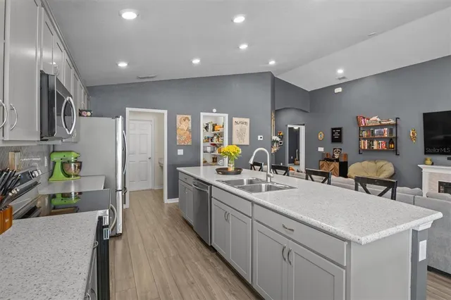 a kitchen with a sink appliances and cabinets
