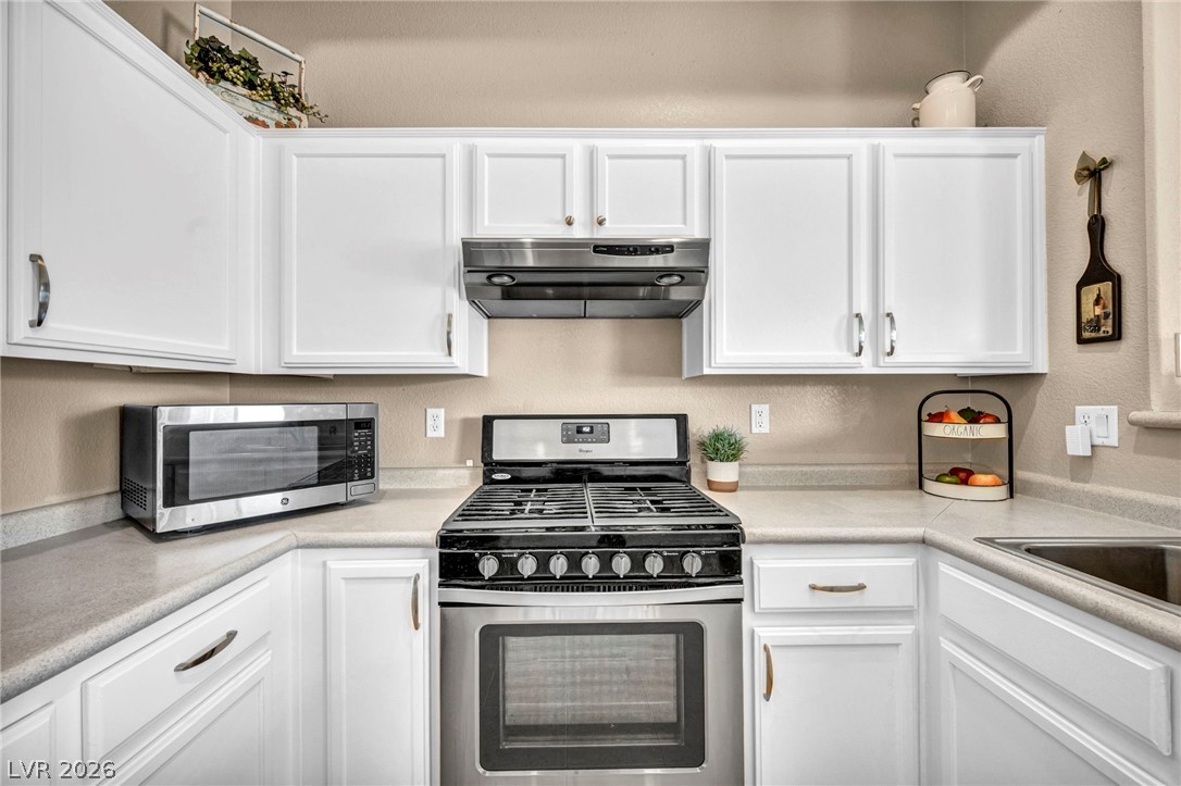 2305 West Horizon Ridge Parkway, Unit 3621 Henderson, NV 89052 - Photo 5 of 23 White cabinetry provides ample storage around a gas range in this well-appointed kitchen.