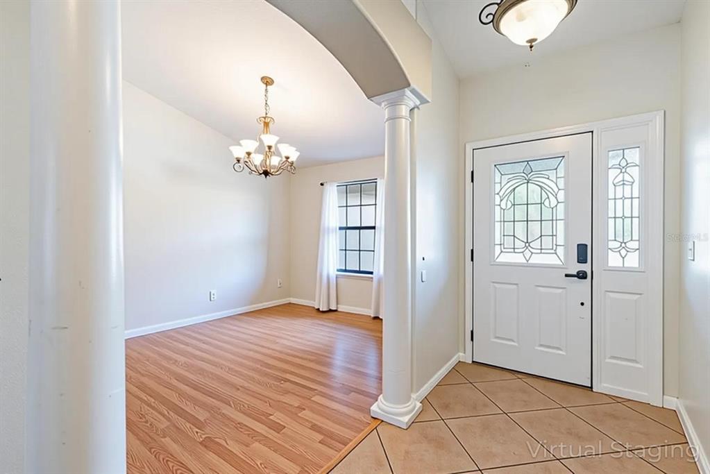 4530 Treasure Cay Road Tavares, FL 32778 - Photo 11 of 60 a room that has a bed and a chandelier