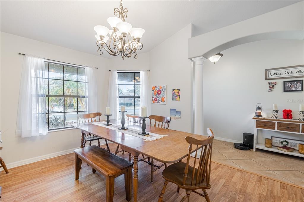 4530 Treasure Cay Road Tavares, FL 32778 - Photo 14 of 60 a view of a dining room with furniture a chandelier and wooden floor