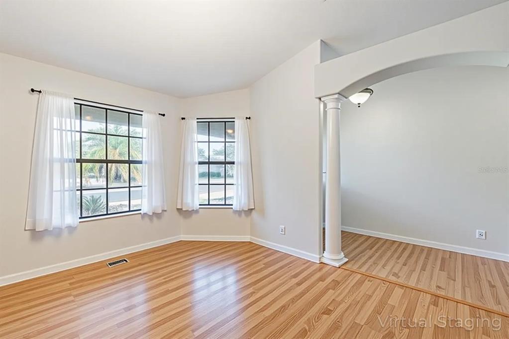 4530 Treasure Cay Road Tavares, FL 32778 - Photo 15 of 60 an empty room with wooden floor and windows