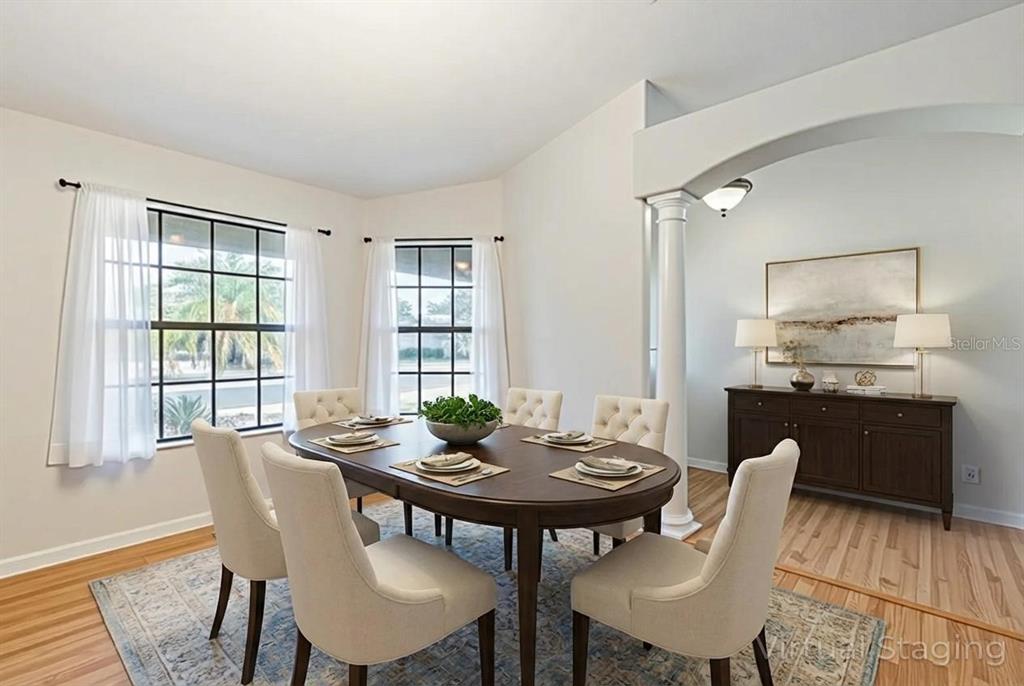 4530 Treasure Cay Road Tavares, FL 32778 - Photo 16 of 60 a view of a dining room with furniture and wooden floor