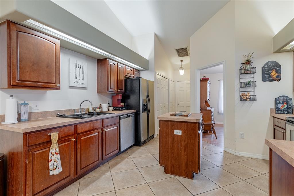 4530 Treasure Cay Road Tavares, FL 32778 - Photo 23 of 60 a large kitchen with stainless steel appliances granite countertop a stove and a sink