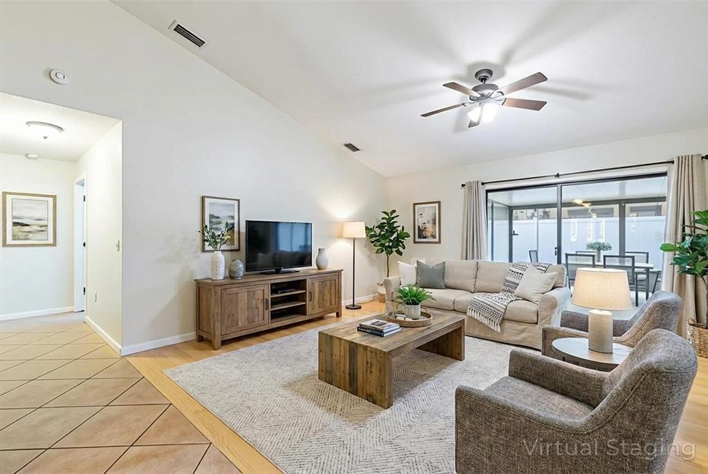 4530 Treasure Cay Road Tavares, FL 32778 - Photo 25 of 60 a living room with furniture and a flat screen tv