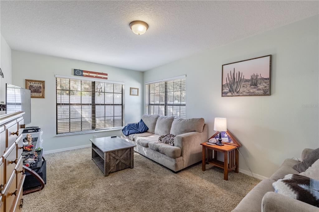 4530 Treasure Cay Road Tavares, FL 32778 - Photo 30 of 60 a living room with furniture and a window