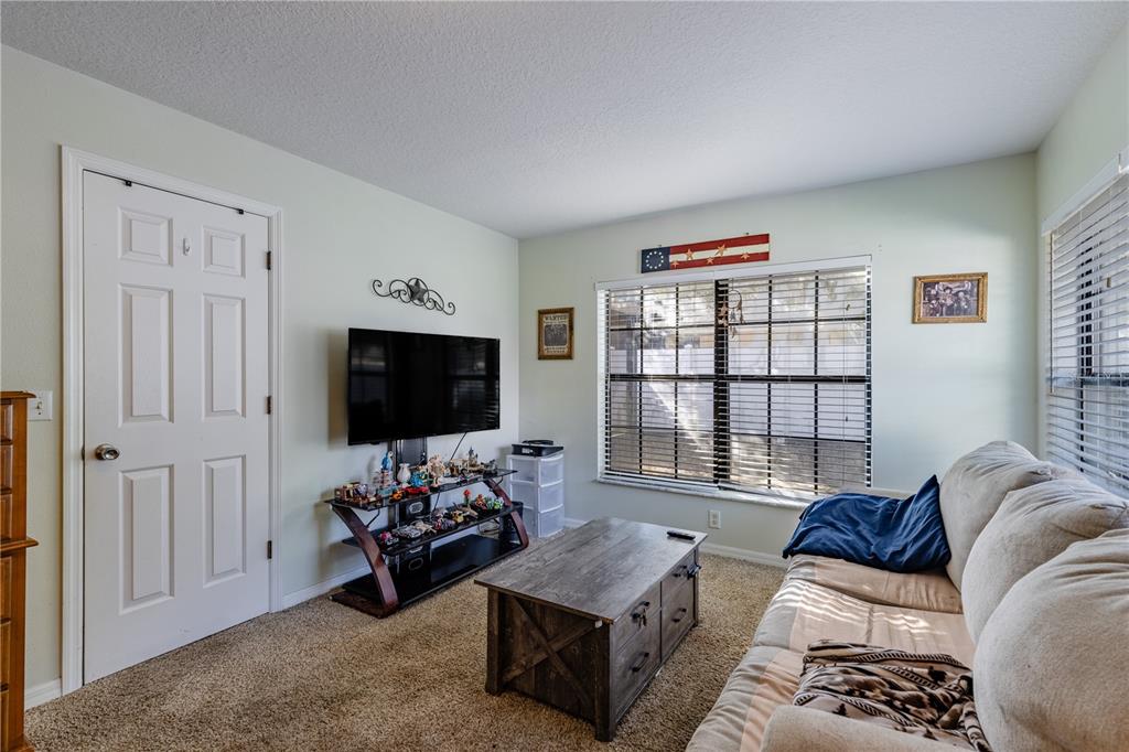 4530 Treasure Cay Road Tavares, FL 32778 - Photo 31 of 60 a living room with furniture and a flat screen tv