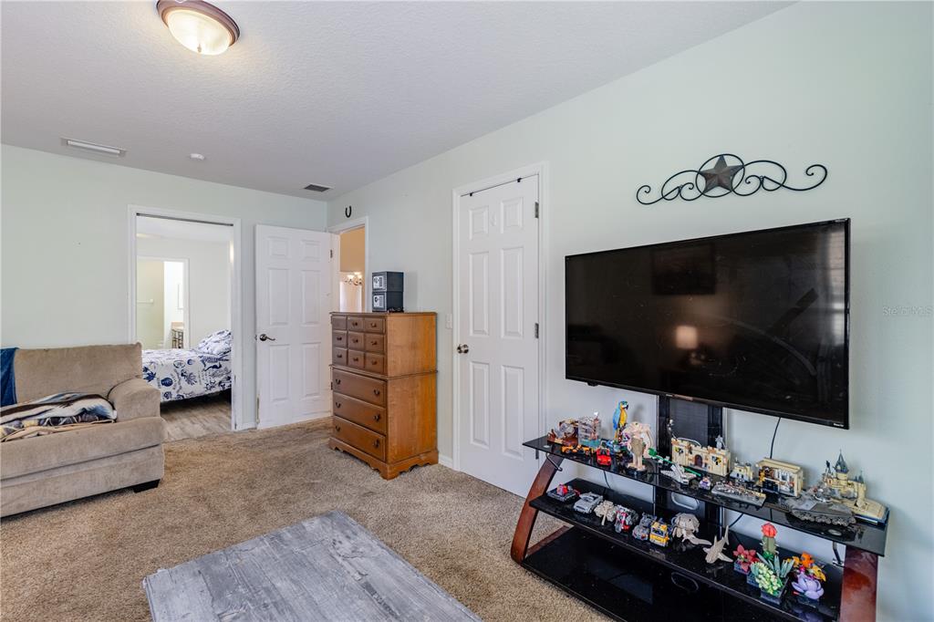 4530 Treasure Cay Road Tavares, FL 32778 - Photo 32 of 60 a room with furniture and a flat screen tv