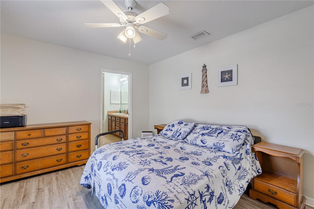 4530 Treasure Cay Road Tavares, FL 32778 - Photo 33 of 60 a bedroom with a bed and a dresser