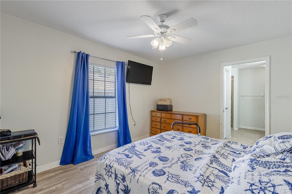 4530 Treasure Cay Road Tavares, FL 32778 - Photo 35 of 60 a bedroom with a bed and wooden floor