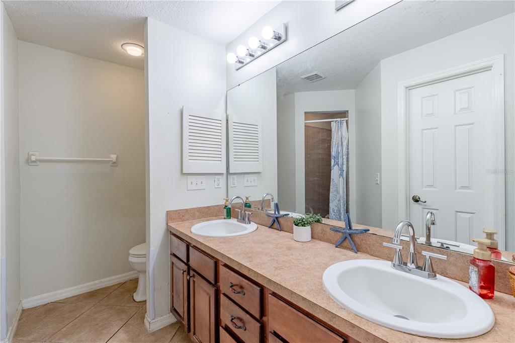 4530 Treasure Cay Road Tavares, FL 32778 - Photo 36 of 60 a bathroom with a sink double vanity and a mirror