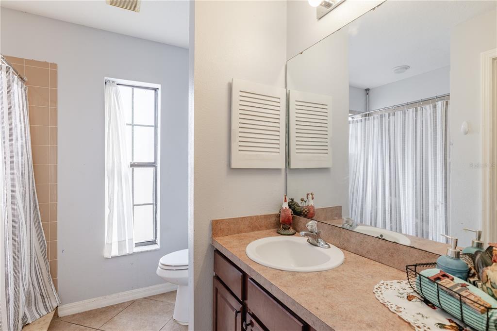 4530 Treasure Cay Road Tavares, FL 32778 - Photo 39 of 60 a bathroom with a granite countertop sink and a mirror