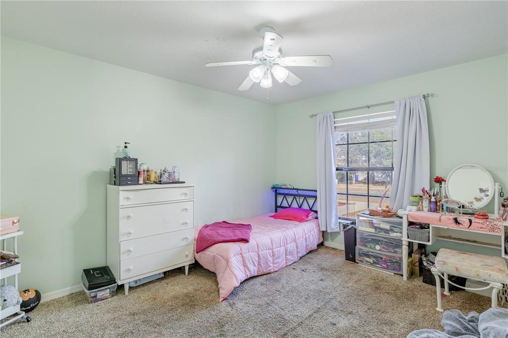 4530 Treasure Cay Road Tavares, FL 32778 - Photo 40 of 60 a bedroom with a bed and a window