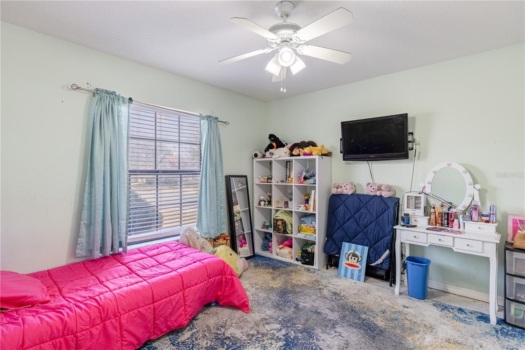 4530 Treasure Cay Road Tavares, FL 32778 - Photo 42 of 60 a bedroom with a bed and a flat screen tv