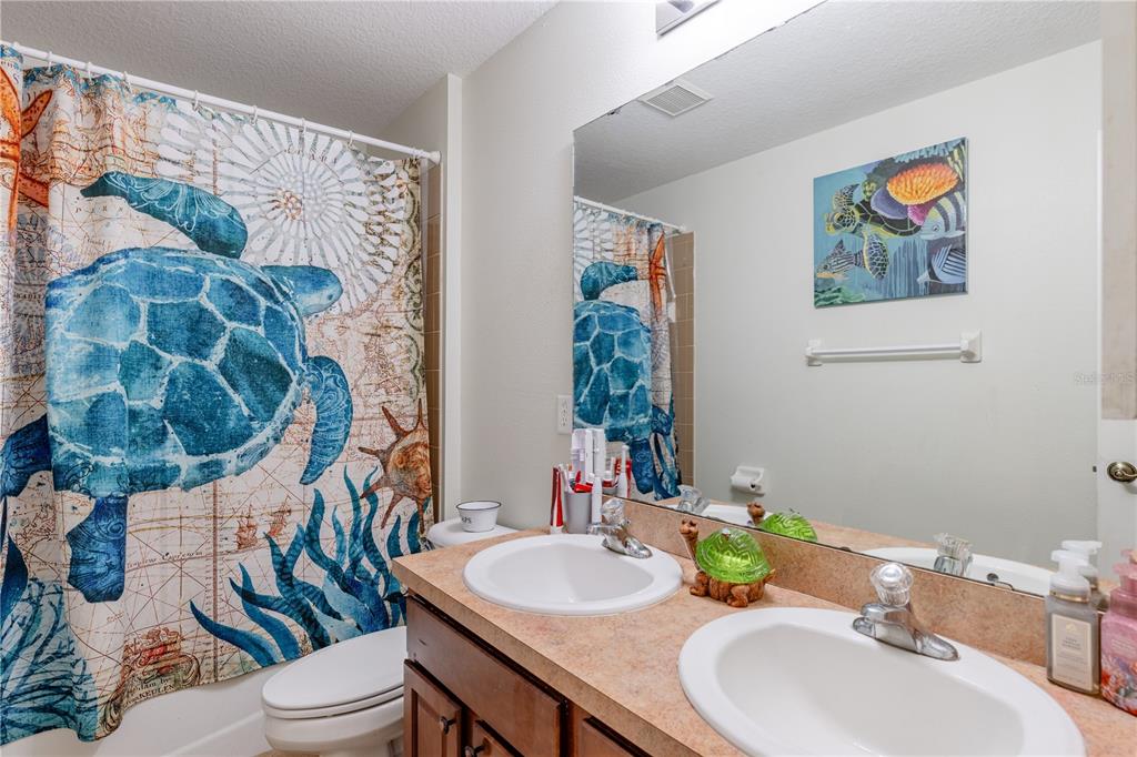 4530 Treasure Cay Road Tavares, FL 32778 - Photo 44 of 60 a bathroom with a sink mirror vanity and toilet