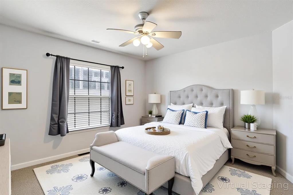 4530 Treasure Cay Road Tavares, FL 32778 - Photo 45 of 60 a bedroom with a bed and a chandelier