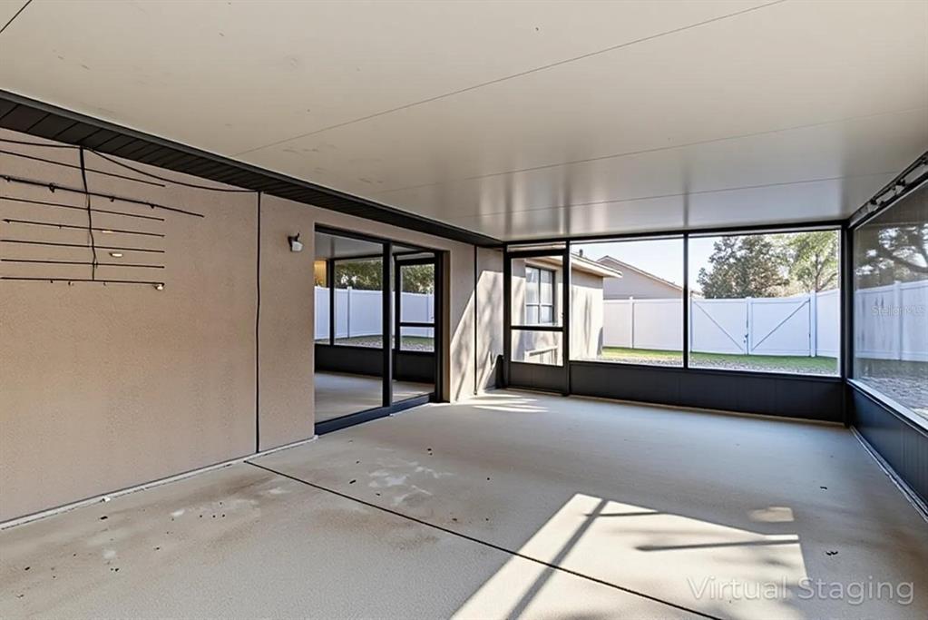 4530 Treasure Cay Road Tavares, FL 32778 - Photo 47 of 60 a view of a big room with windows and chandelier