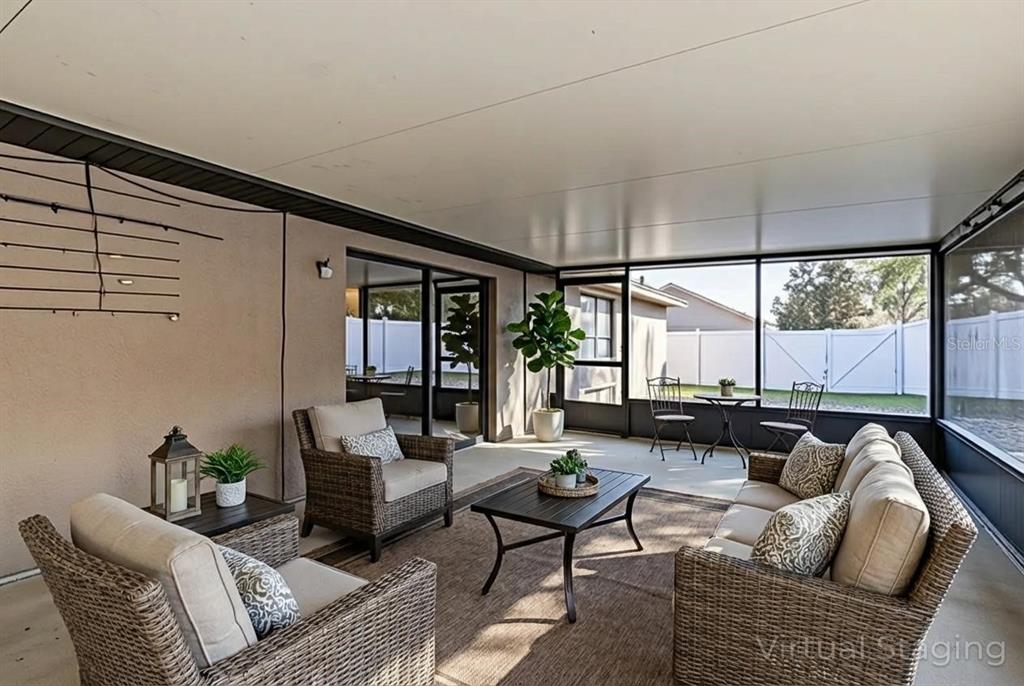 4530 Treasure Cay Road Tavares, FL 32778 - Photo 49 of 60 a living room with furniture and a large window