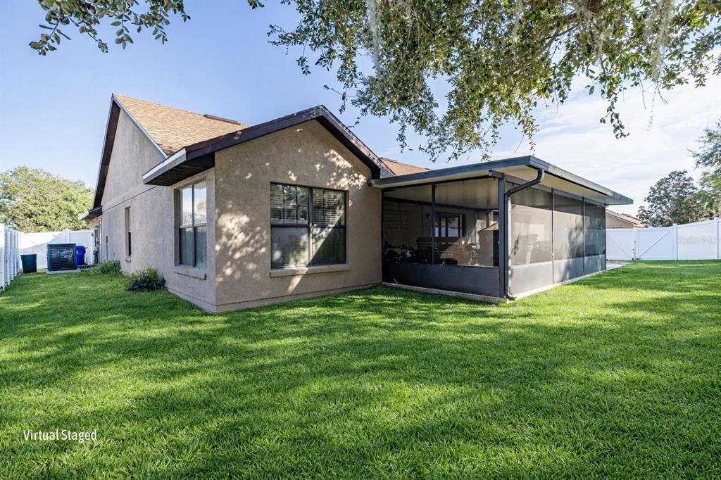4530 Treasure Cay Road Tavares, FL 32778 - Photo 52 of 60 a front view of a house with a garden and yard