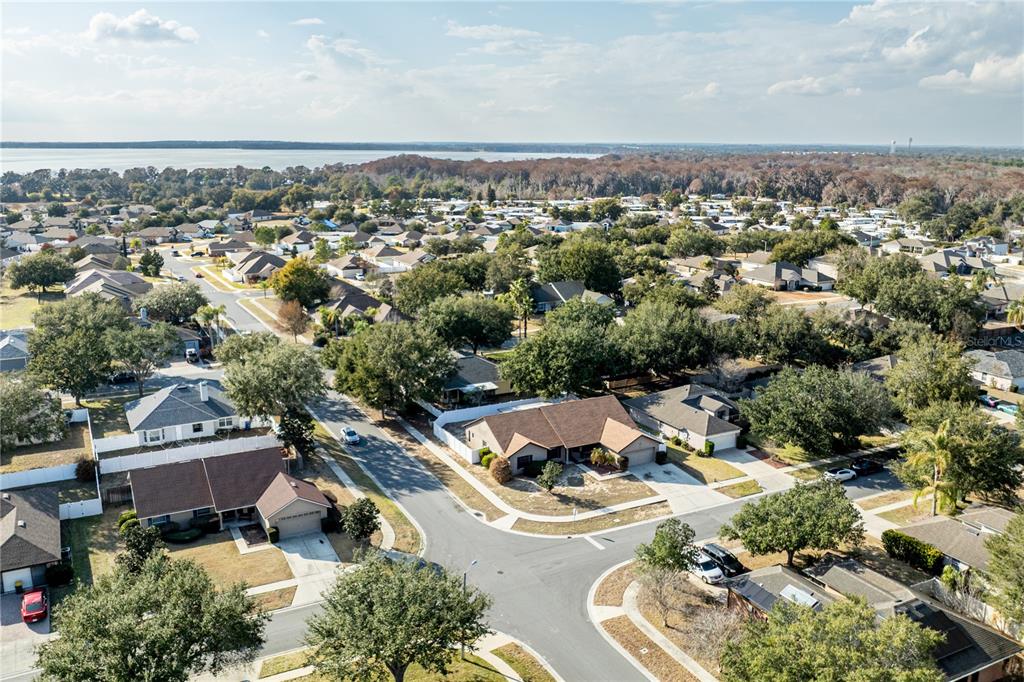 4530 Treasure Cay Road Tavares, FL 32778 - Photo 58 of 60 an aerial view of a house with a swimming pool outdoor seating and yard