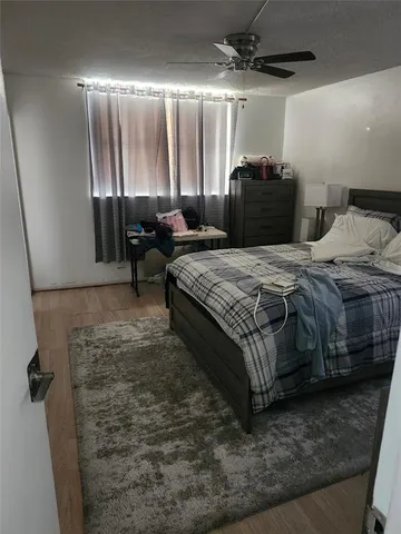 a bedroom with bed and window