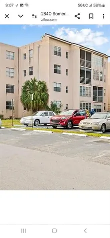 a bathroom with a sink a toilet a mirror and shower