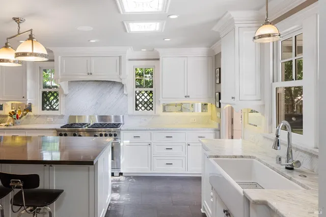 a living room with furniture fireplace and a large window