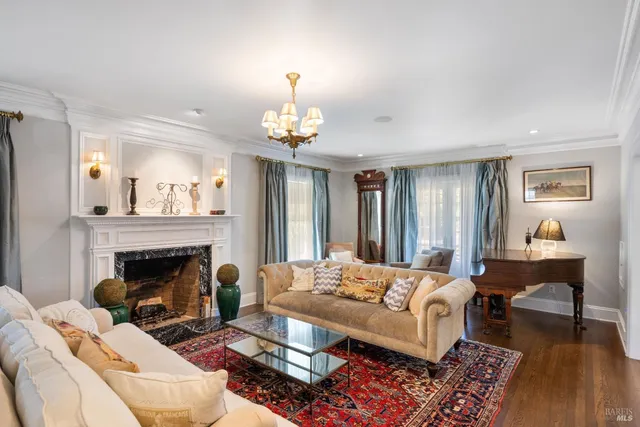 a bed sitting in a spacious bedroom next to a window