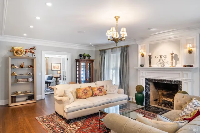 a bedroom with a large bed and a chandelier