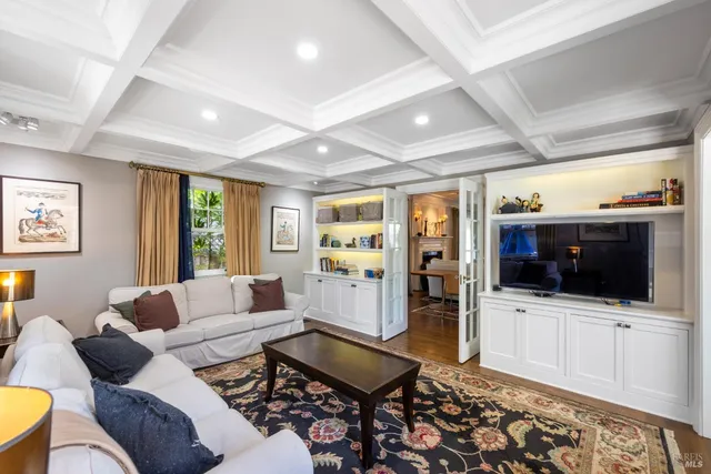 a bedroom with furniture and large windows