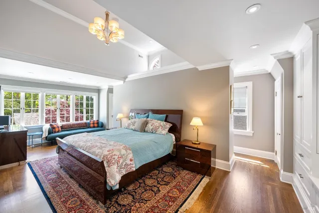 a bedroom with a bed and a chandelier