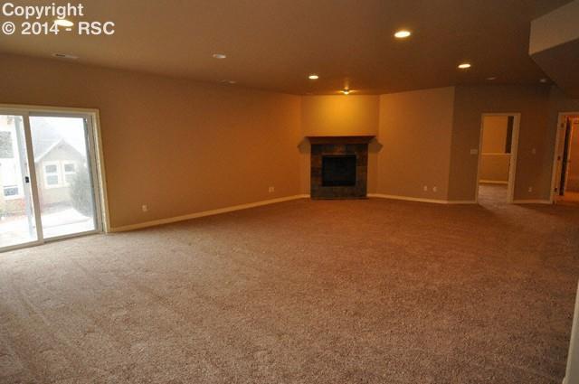 15892 Maple Hill Road Monument, CO 80132 - Photo 16 of 22 Massive rec room that walks out with gas fireplace