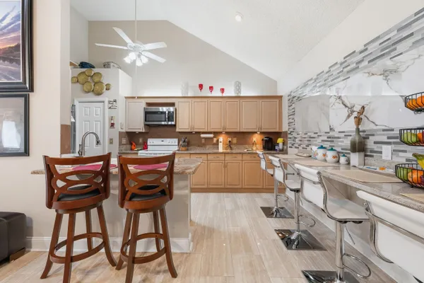 a kitchen with stainless steel appliances granite countertop a refrigerator and a stove