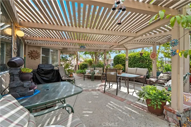 a view of a patio with a table chairs and a backyard