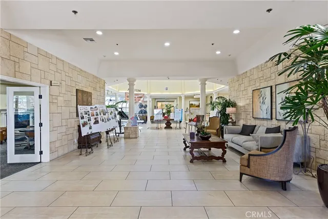 a living room with furniture and potted plants