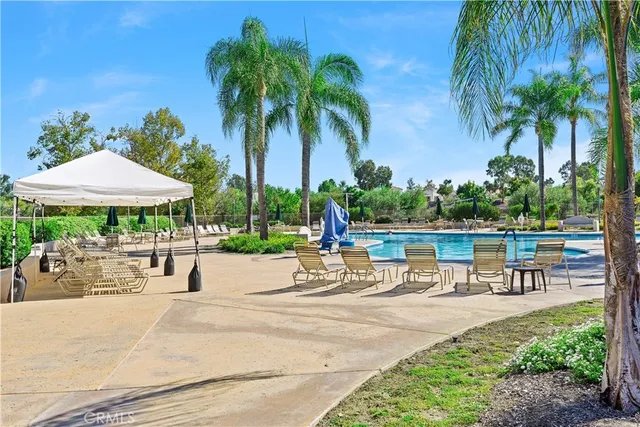 a row of lawn chairs under an umbrella