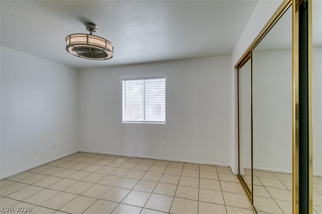 7570 West Flamingo Road, Unit 252 Las Vegas, NV 89147 - Photo 32 of 44 A quiet retreat, this bedroom features resilient tile flooring and a mirrored closet.