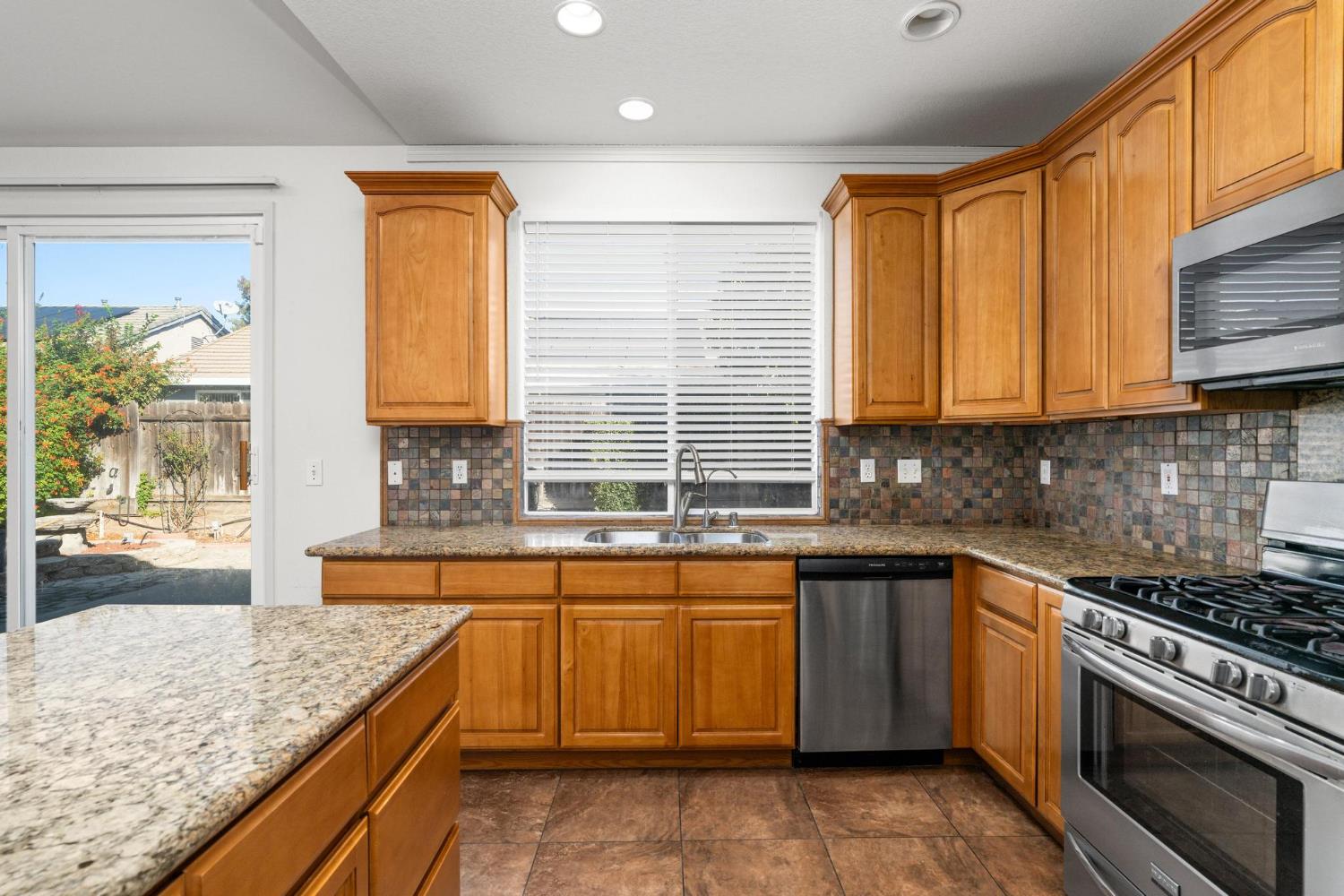 1833 Rail Street Manteca, CA 95337 - Photo 11 of 40 a kitchen with a sink stove top oven and cabinets