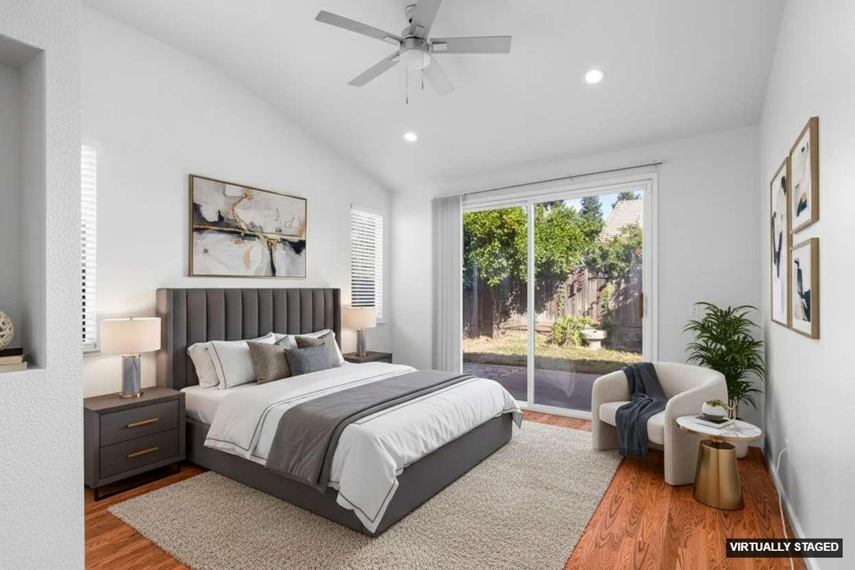 1833 Rail Street Manteca, CA 95337 - Photo 16 of 40 a bedroom with a large bed and a chandelier