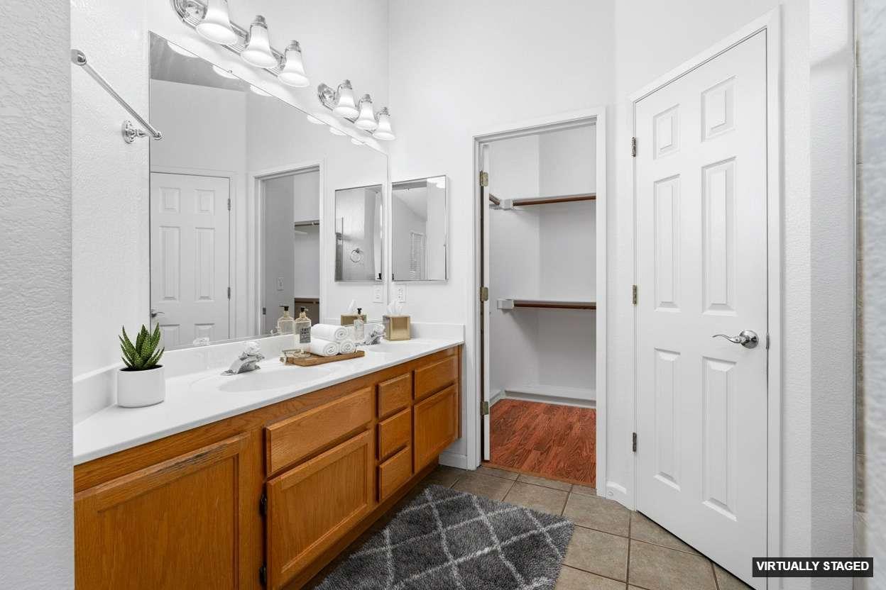 1833 Rail Street Manteca, CA 95337 - Photo 19 of 40 a bathroom with a double vanity sink and a mirror
