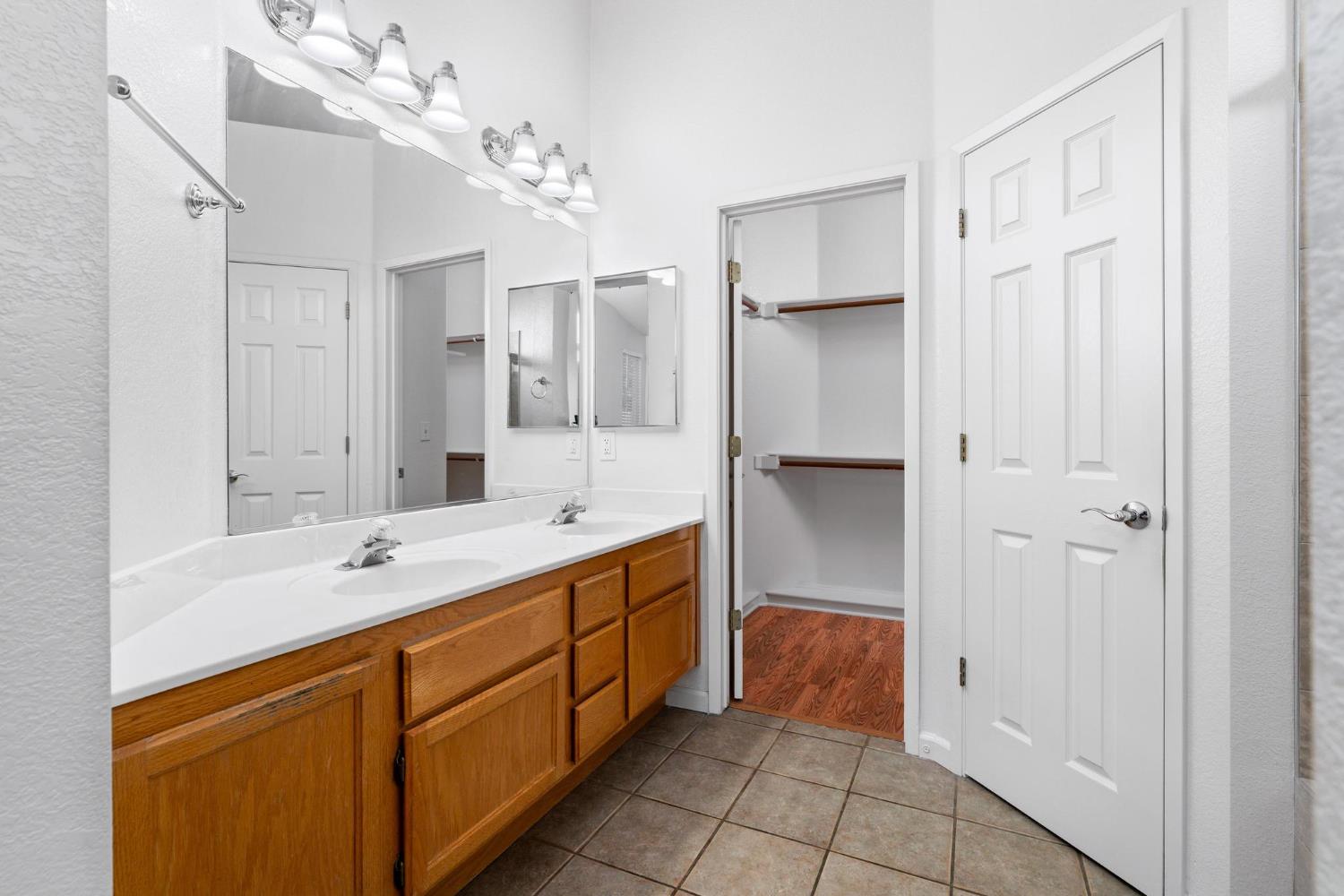 1833 Rail Street Manteca, CA 95337 - Photo 20 of 40 a spacious bathroom with a double vanity sink a mirror and a shower