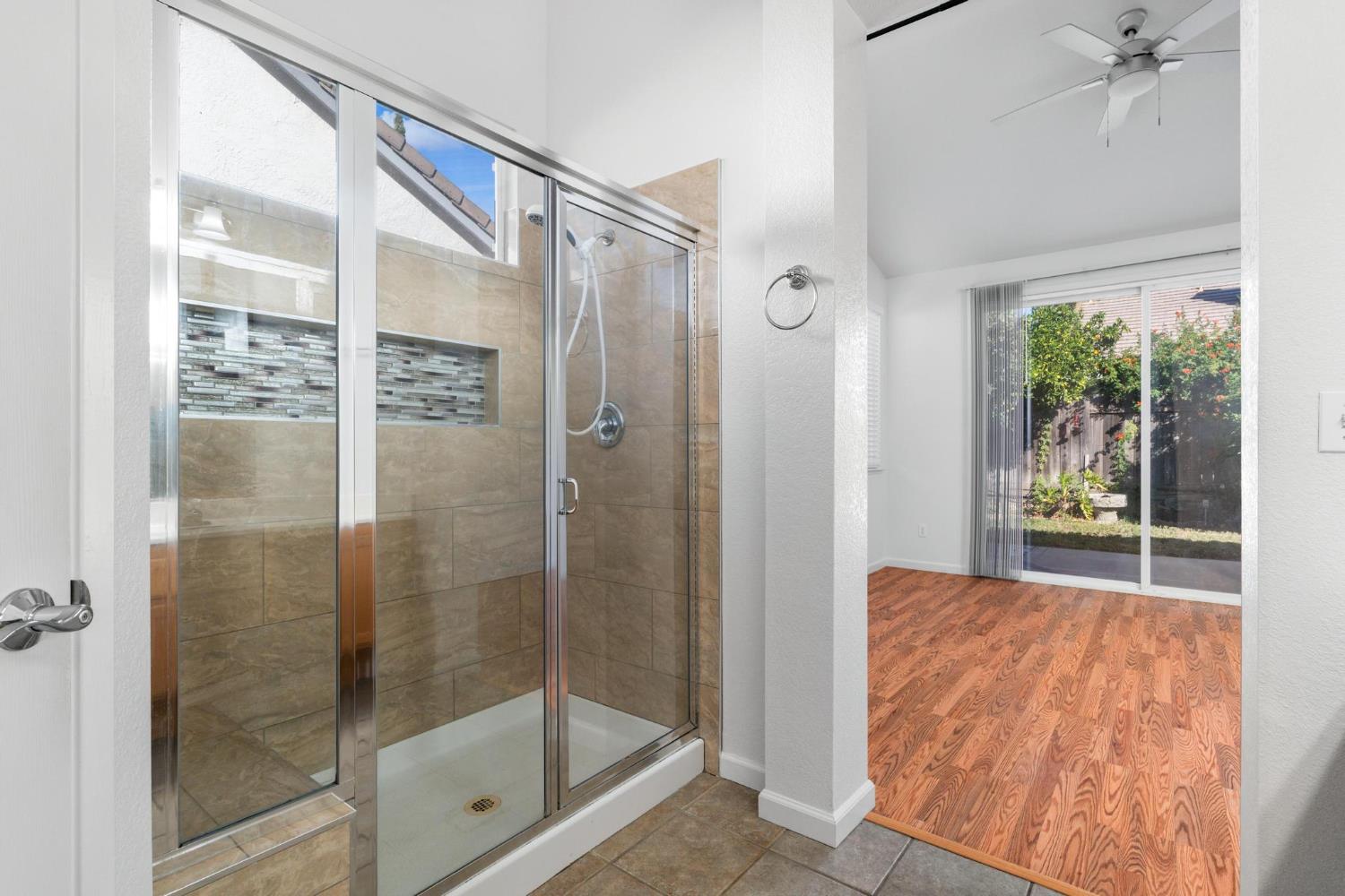 1833 Rail Street Manteca, CA 95337 - Photo 21 of 40 a bathroom with a glass shower door