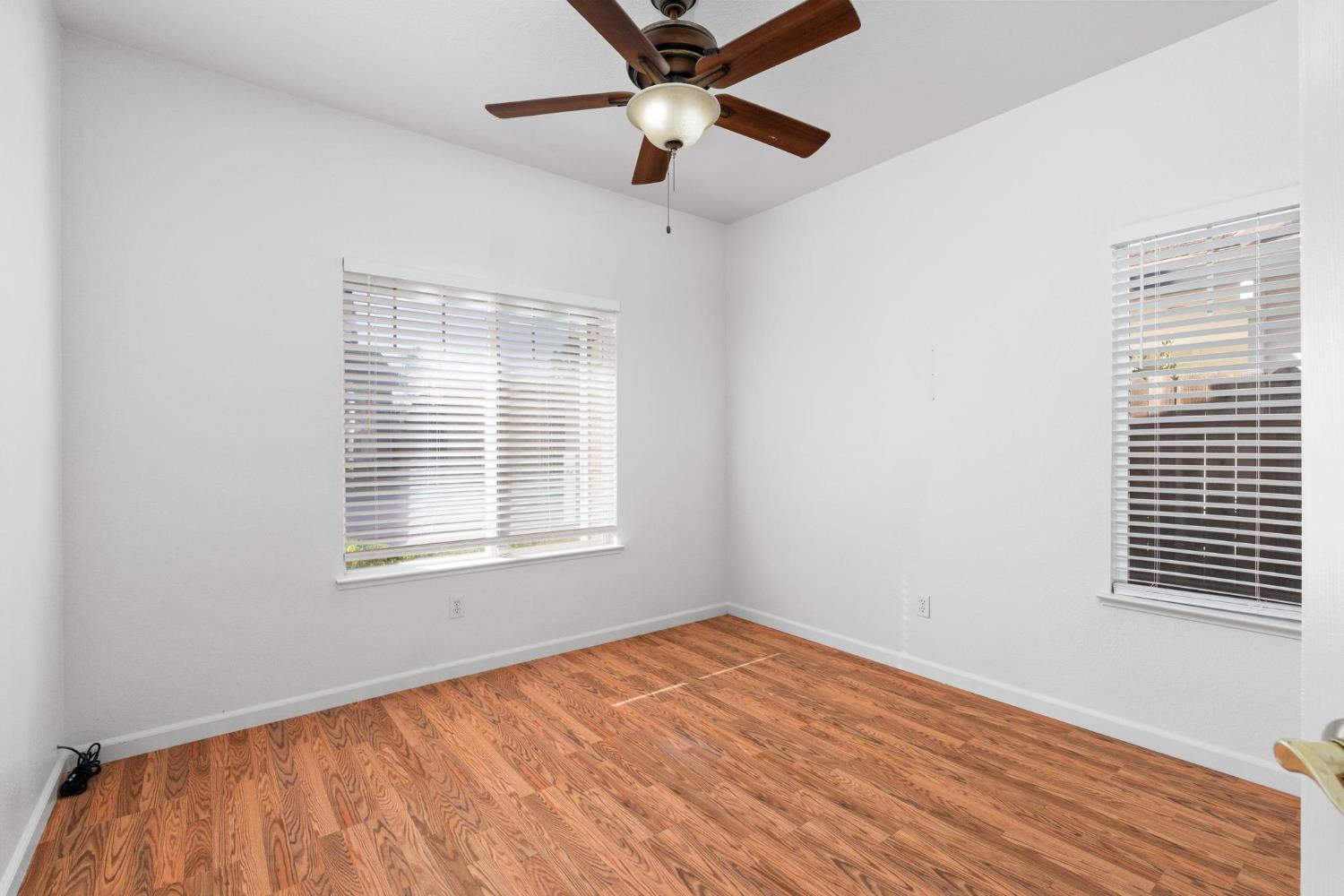 1833 Rail Street Manteca, CA 95337 - Photo 24 of 40 a view of an empty room with a window and wooden floor